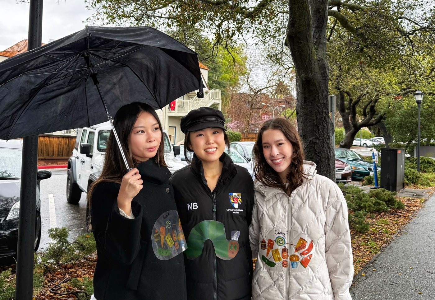 Nicole and friends under an umbrella