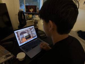 A playtester exploring Remnant on a laptop at home